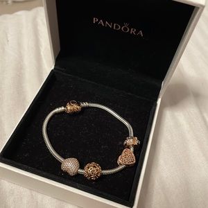 Rose gold pandora bracelet with 4 charms included. Rarely worn, looks like new!